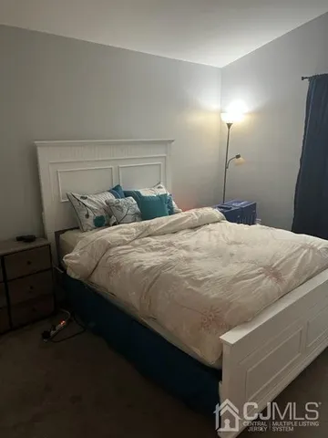 a bedroom with a bed and a night stand