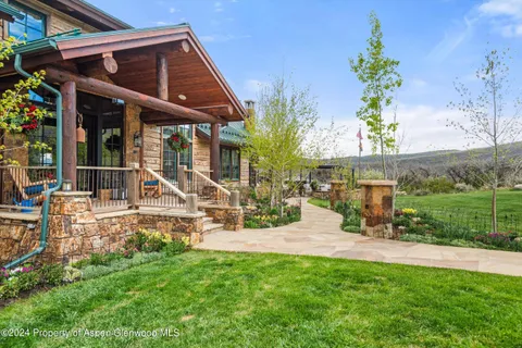 front view of house with a yard and sitting area