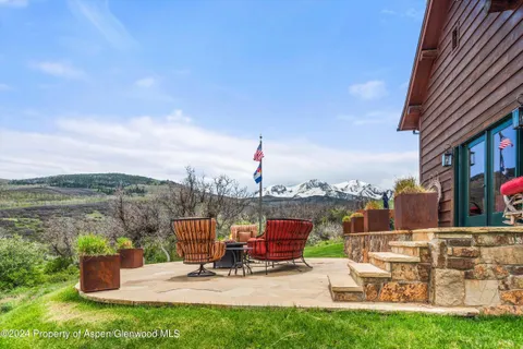 a view of a patio with a table and chairs