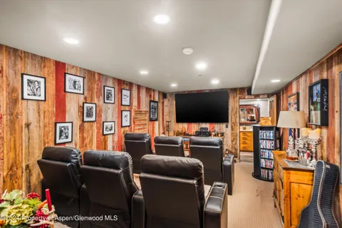 a media room with lots of chairs and a projector screen