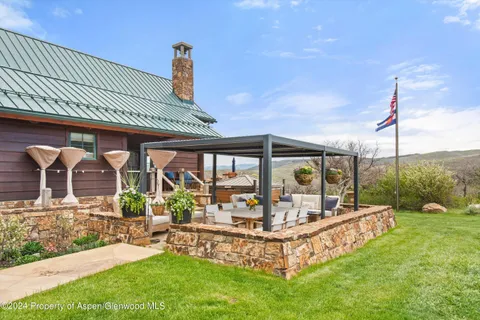a view of a house with a backyard porch and sitting area