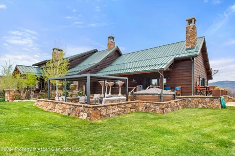 a front view of a house with a garden and patio