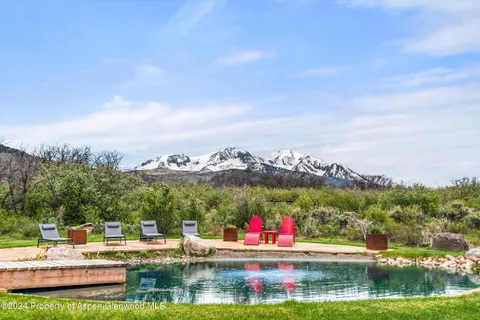 a view of a city with lawn chairs and a big yard