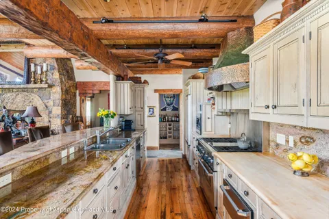 a kitchen with stainless steel appliances granite countertop a lot of counter space