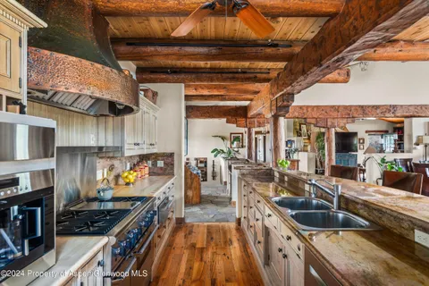 a kitchen with wooden cabinets and a stove top oven