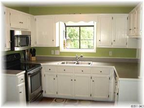 8406 Fairfield Forest Road Denver, NC 28037 - Photo 8 of 16 a kitchen with a sink a stove and cabinets
