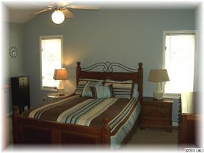 8406 Fairfield Forest Road Denver, NC 28037 - Photo 10 of 16 a bedroom with a bed and wooden floor