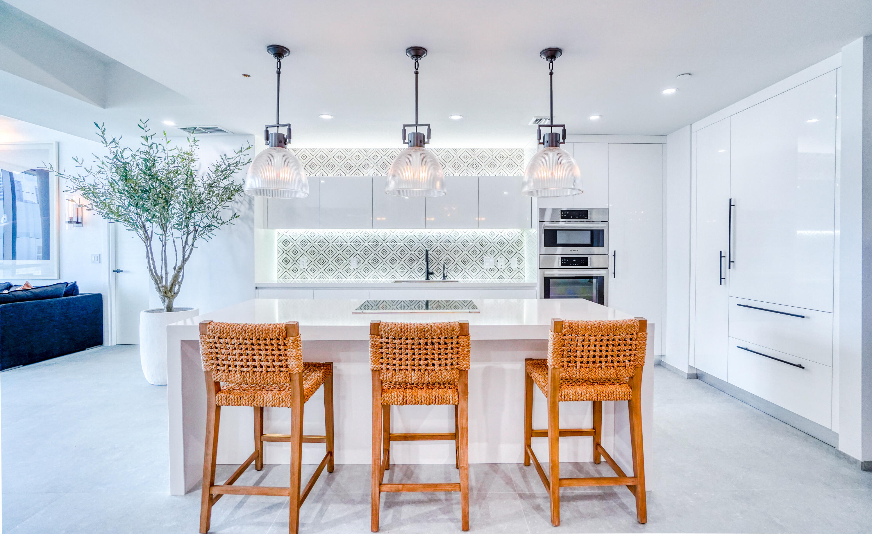 851 Northeast 1st Avenue, Unit 812 Miami, FL 33132 - Photo 24 of 84 a kitchen with stainless steel appliances kitchen island granite countertop a table and chairs in it