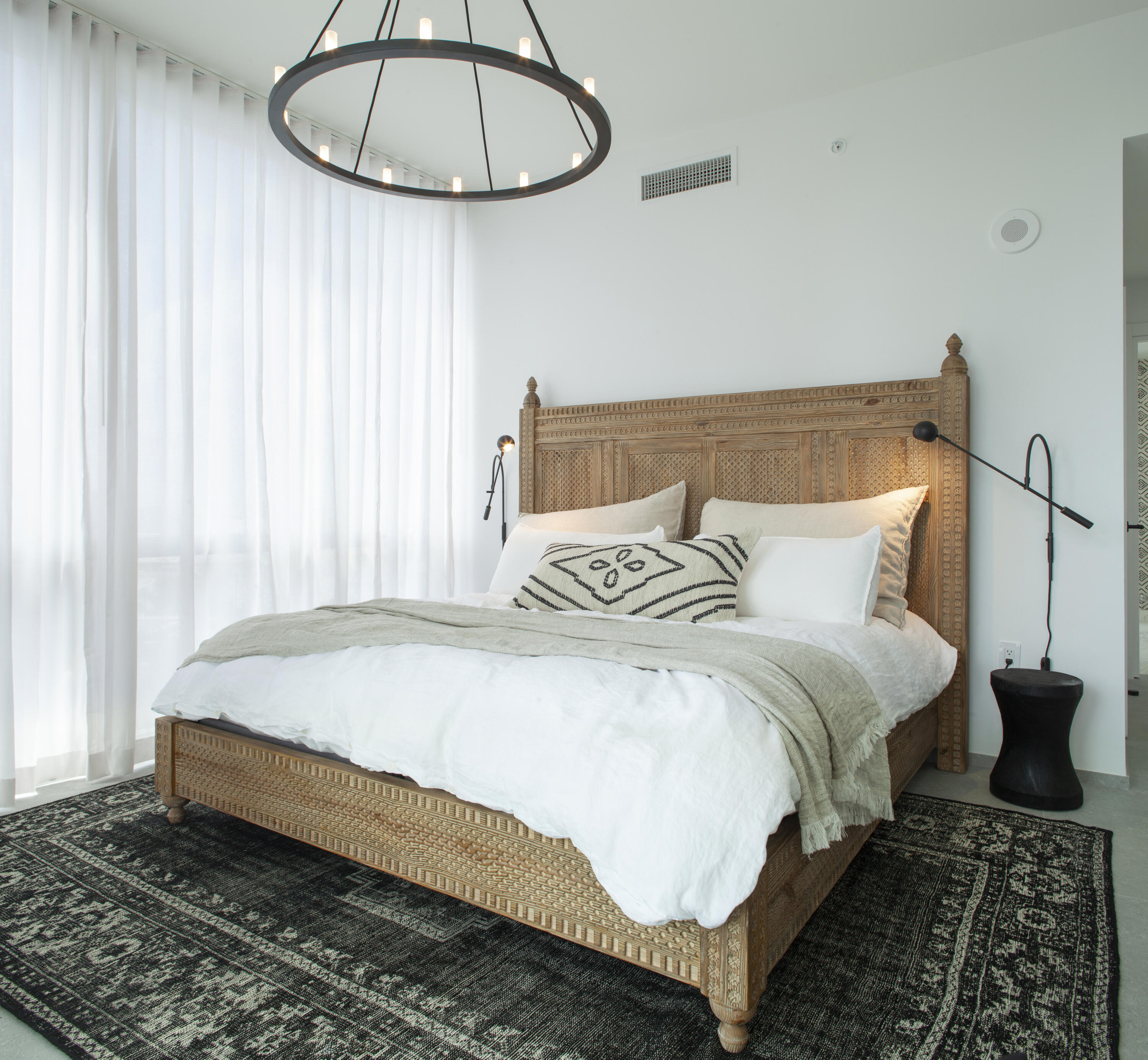 851 Northeast 1st Avenue, Unit 812 Miami, FL 33132 - Photo 29 of 84 a bedroom with a bed a window and a chandelier