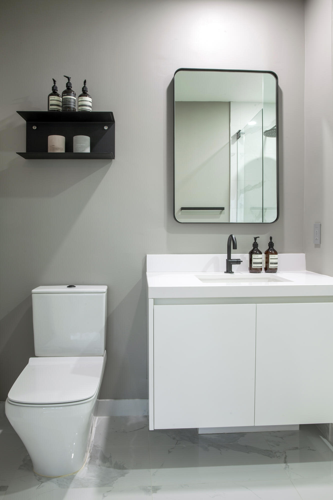 851 Northeast 1st Avenue, Unit 812 Miami, FL 33132 - Photo 40 of 84 a bathroom with a toilet a sink and mirror