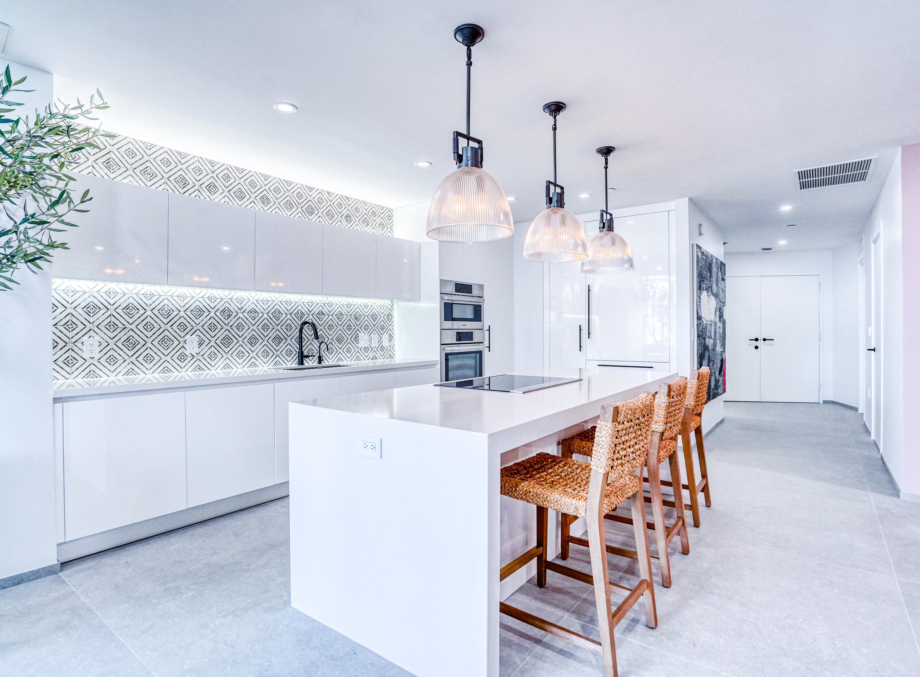 851 Northeast 1st Avenue, Unit 812 Miami, FL 33132 - Photo 45 of 84 an open kitchen with a table and chairs