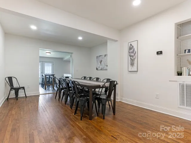 a view of a a dining room with furniture window and wooden floor