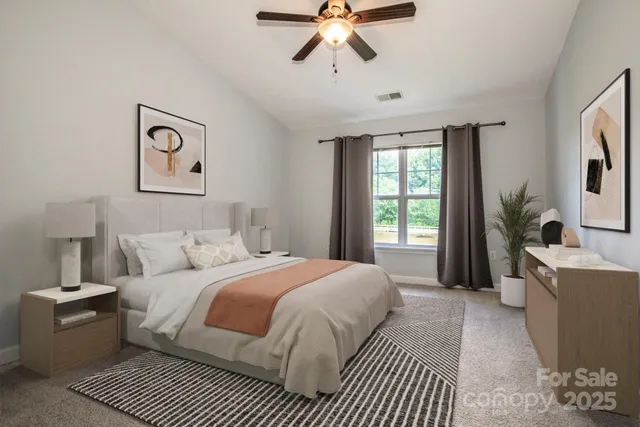 a view of a big room with windows and chandelier fan