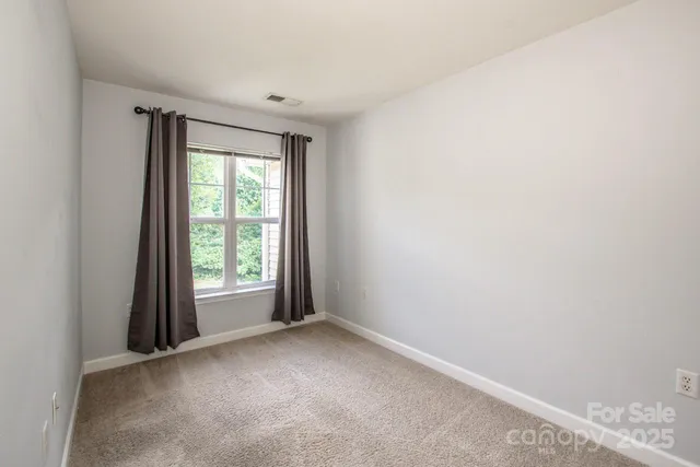 a room with gym equipment and a large window