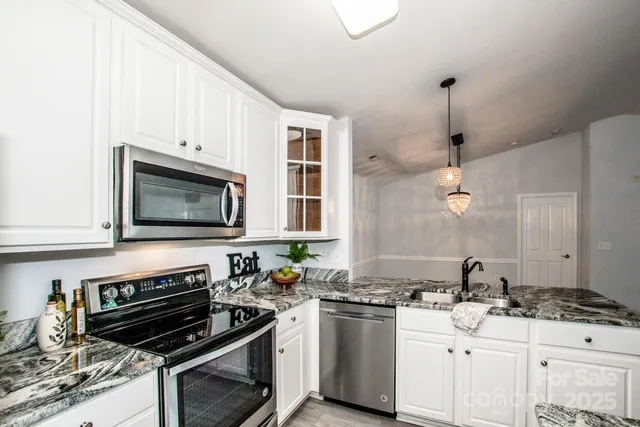 a view of kitchen with sink microwave and refrigerator