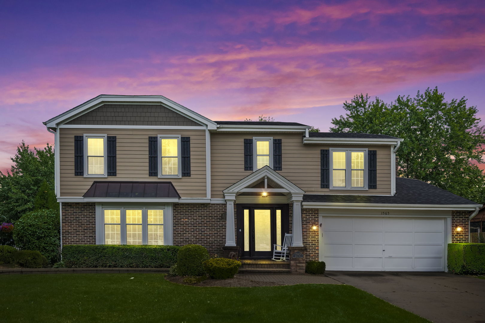 1565 Freeman Road Hoffman Estates, IL 60192 - Photo 45 of 46 a front view of a house with a yard and garage