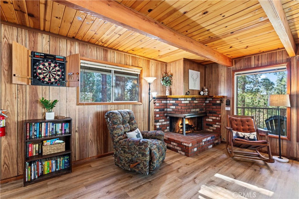 930 Bear Mountain Road Big Bear City, CA 92314 - Photo 11 of 39 a living room with furniture fireplace and a large window