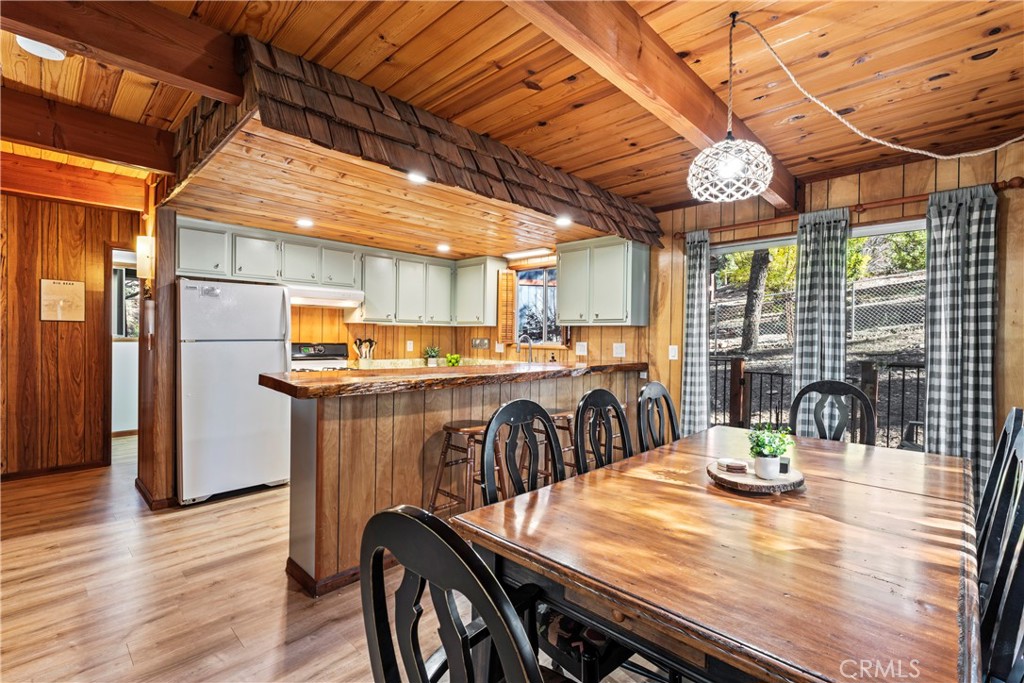 930 Bear Mountain Road Big Bear City, CA 92314 - Photo 15 of 39 a view of a dining room with furniture window and wooden floor