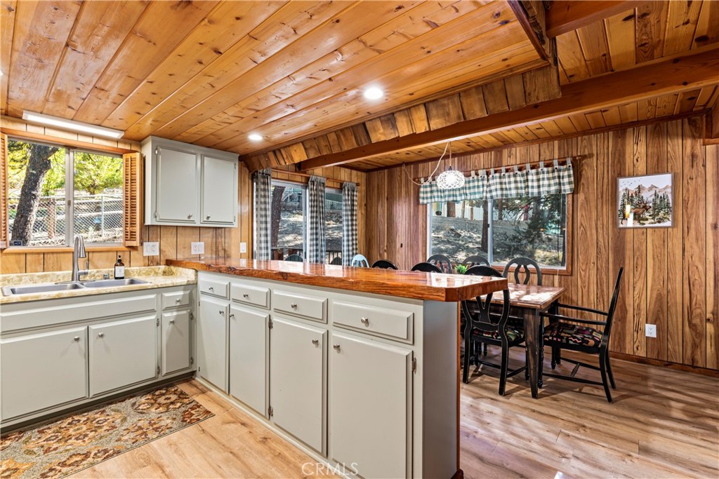 930 Bear Mountain Road Big Bear City, CA 92314 - Photo 39 of 39 a kitchen with stainless steel appliances granite countertop table chairs and a large window