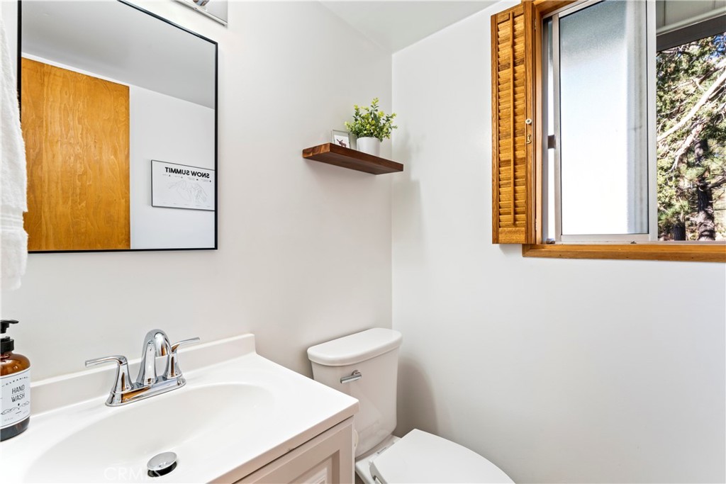 930 Bear Mountain Road Big Bear City, CA 92314 - Photo 18 of 39 a bathroom with a sink a toilet and mirror
