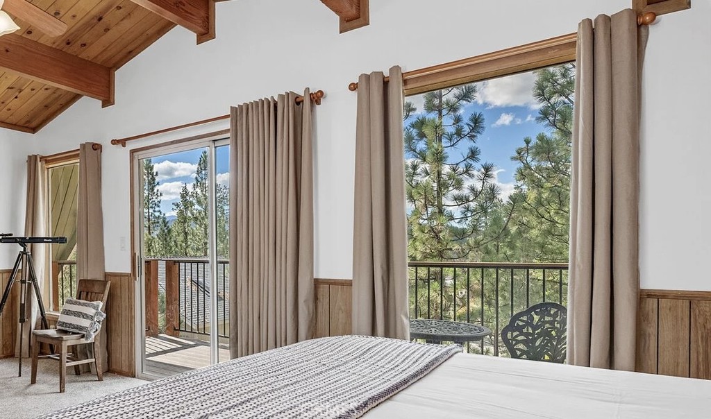 930 Bear Mountain Road Big Bear City, CA 92314 - Photo 22 of 39 a bedroom with a bed and a large window