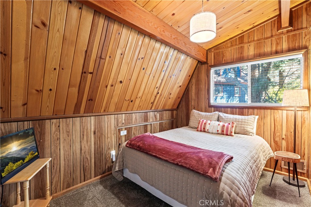 930 Bear Mountain Road Big Bear City, CA 92314 - Photo 25 of 39 a bedroom with a bed and wooden floor