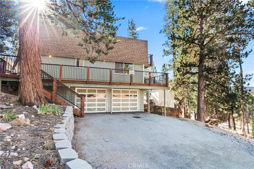 930 Bear Mountain Road Big Bear City, CA 92314 - Photo 27 of 39 a view of front red house with a tree