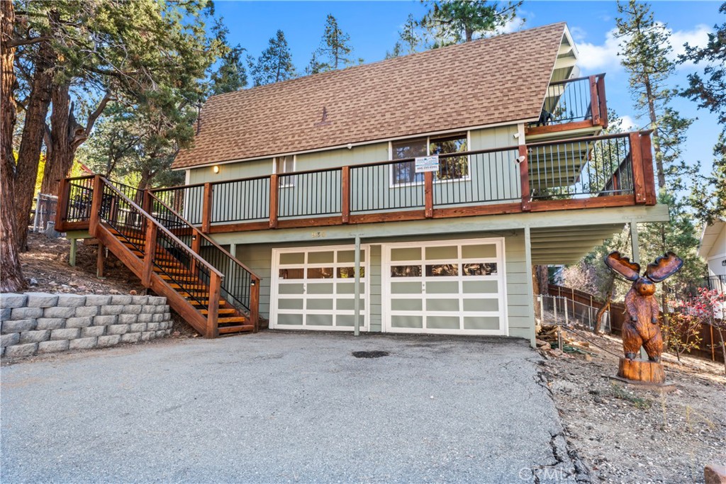930 Bear Mountain Road Big Bear City, CA 92314 - Photo 28 of 39 a front view of a house with a yard and garage