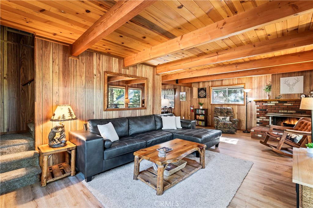 930 Bear Mountain Road Big Bear City, CA 92314 - Photo 6 of 39 a living room with furniture a wooden floor and a table