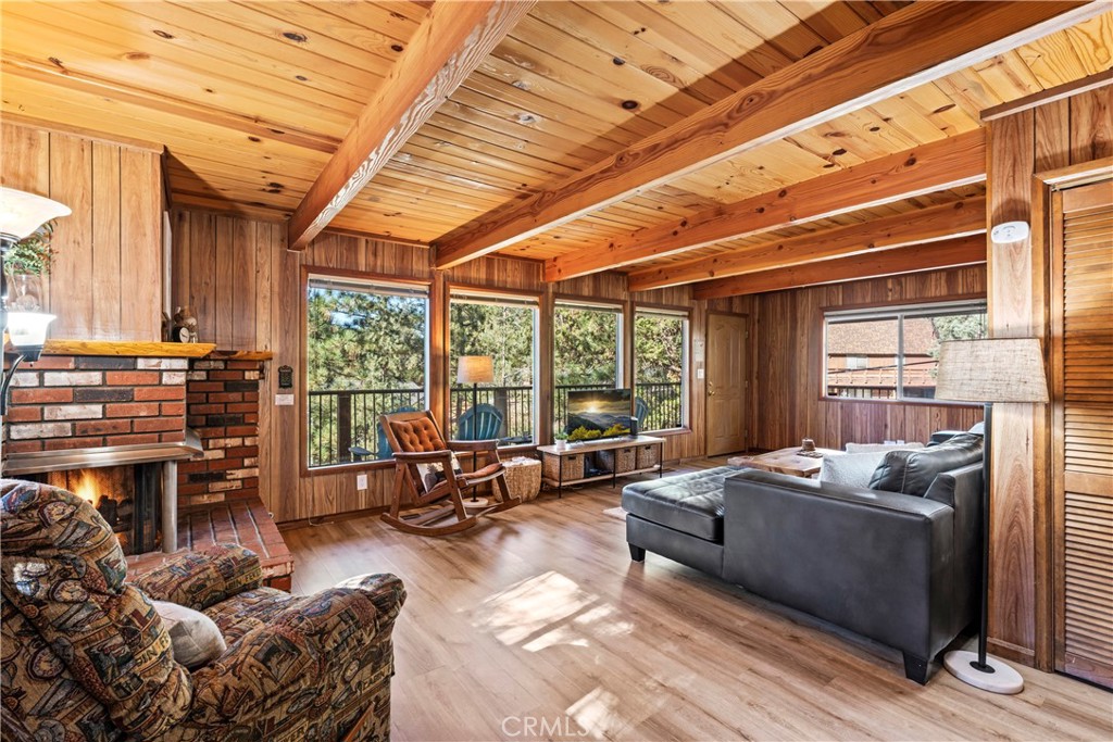 930 Bear Mountain Road Big Bear City, CA 92314 - Photo 10 of 39 a living room with furniture fireplace and large windows
