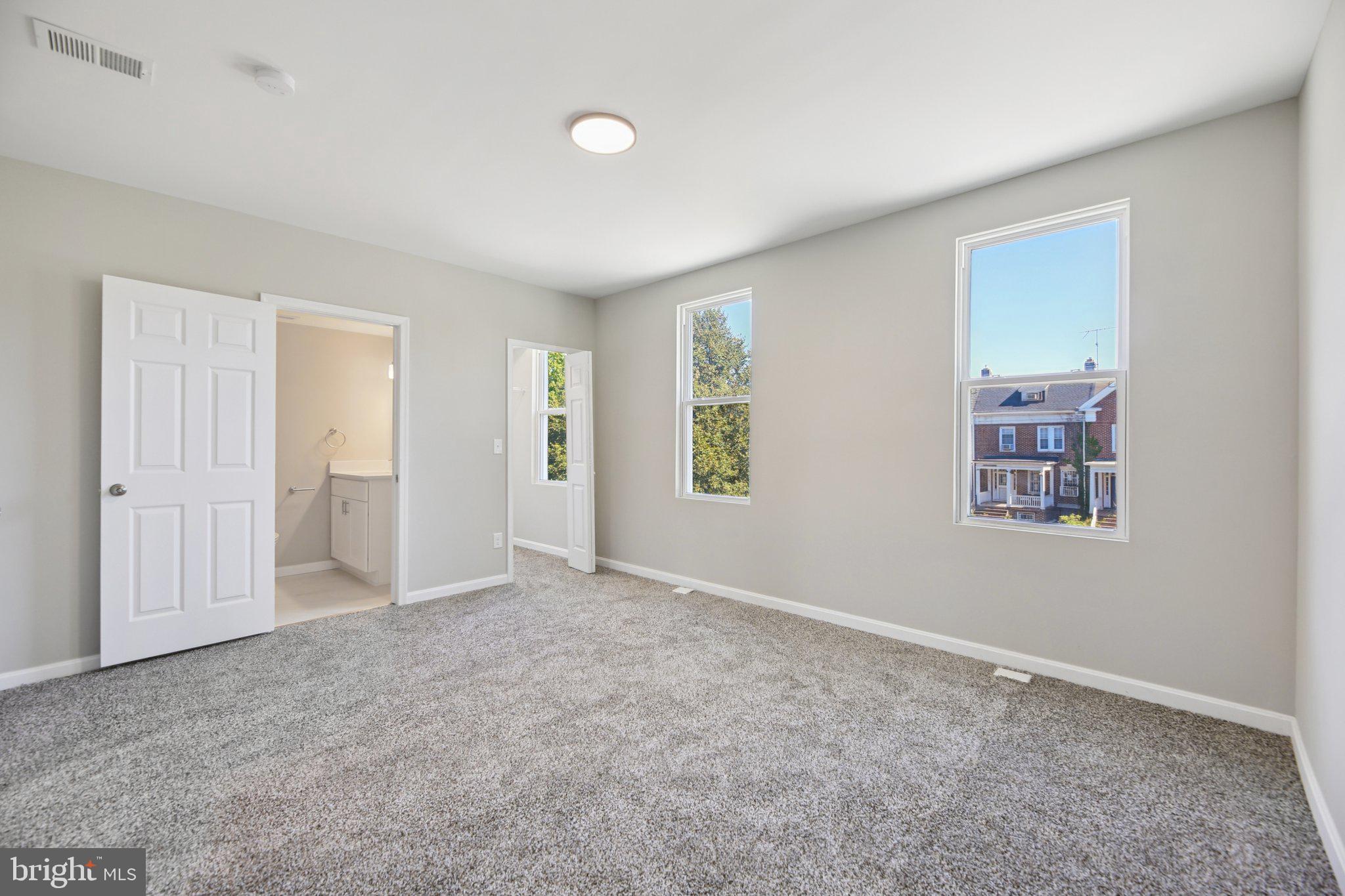 329 East University Parkway Baltimore, MD 21218 - Photo 19 of 38 an empty room with windows and closet