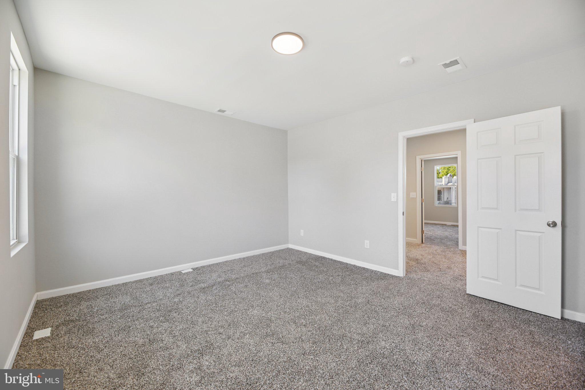 329 East University Parkway Baltimore, MD 21218 - Photo 20 of 38 an empty room with closet and windows