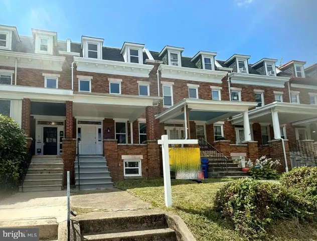 a front view of a residential apartment building with a yard