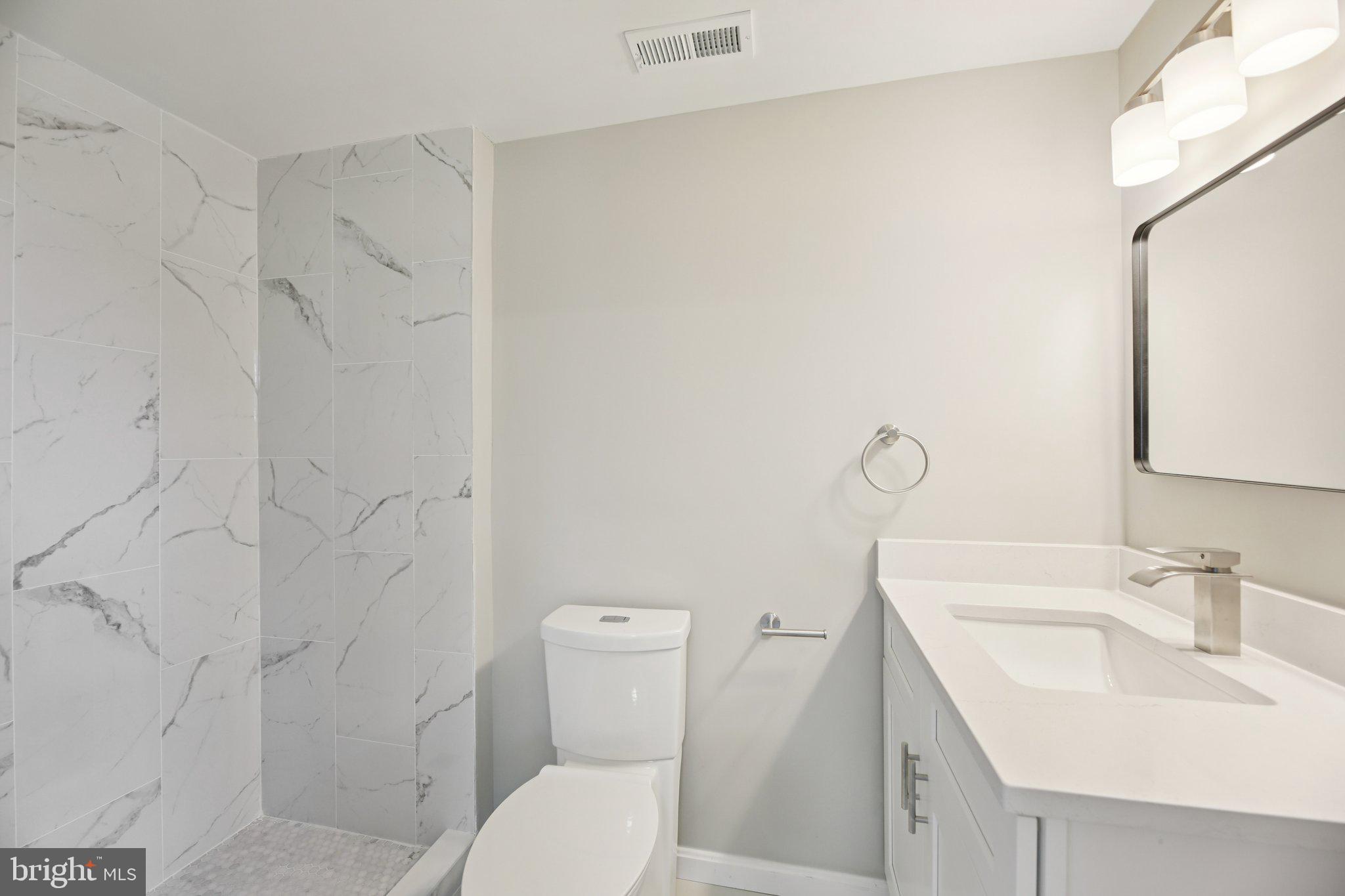 329 East University Parkway Baltimore, MD 21218 - Photo 21 of 38 a bathroom with a sink toilet and shower