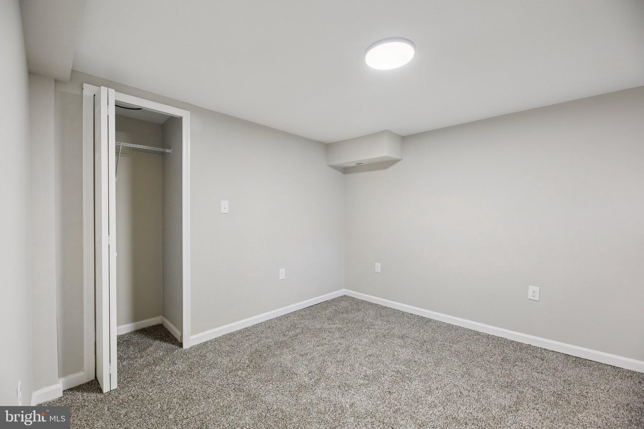 329 East University Parkway Baltimore, MD 21218 - Photo 32 of 38 an empty room with a empty space and a window