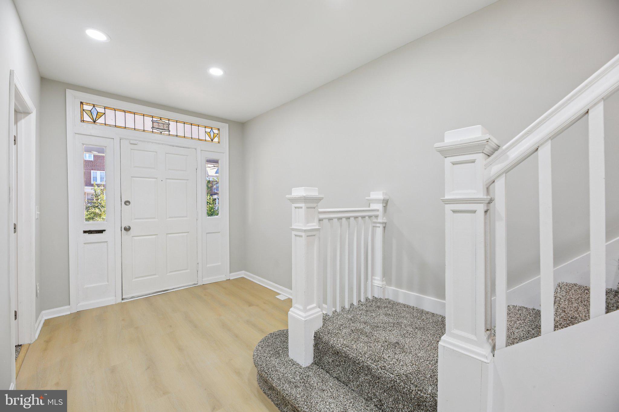 329 East University Parkway Baltimore, MD 21218 - Photo 4 of 38 a view of a livingroom with wooden floor and entryway