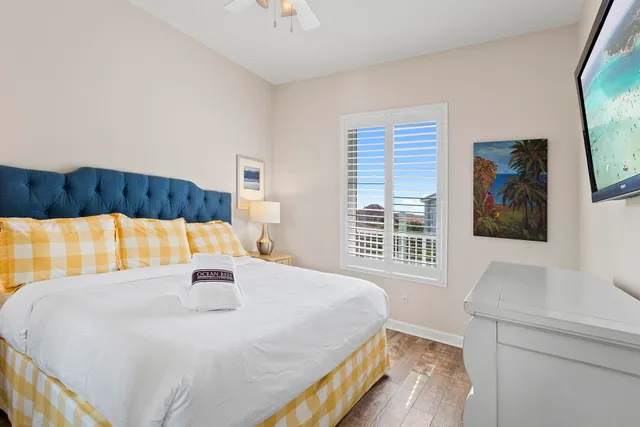 a bed sitting in a bedroom next to a window