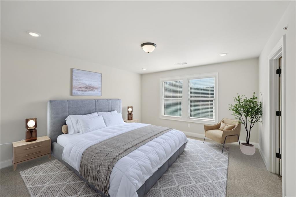 6440 Pinin Place Cumming, GA 30041 - Photo 40 of 52 a spacious bedroom with a bed and glass window