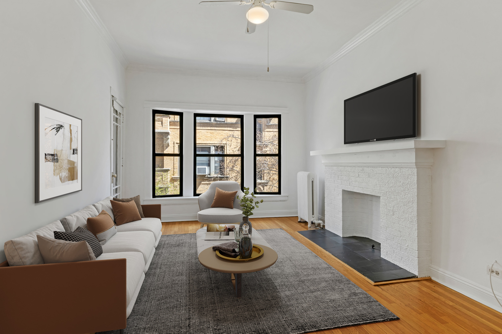 728 West Sheridan Road, Unit 2N Chicago, IL 60613 - Photo 2 of 18 a living room with furniture a flat screen tv and a fireplace
