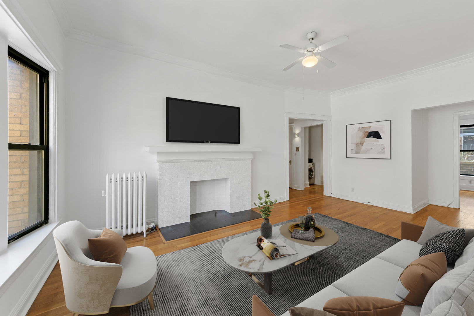 728 West Sheridan Road, Unit 2N Chicago, IL 60613 - Photo 4 of 18 a living room with furniture a fireplace and a flat screen tv
