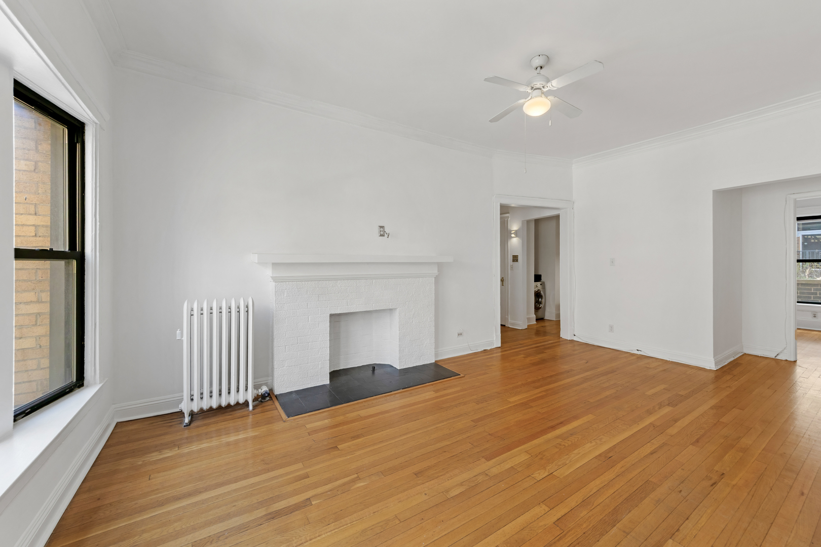 728 West Sheridan Road, Unit 2N Chicago, IL 60613 - Photo 5 of 18 a view of empty room with wooden floor and fan