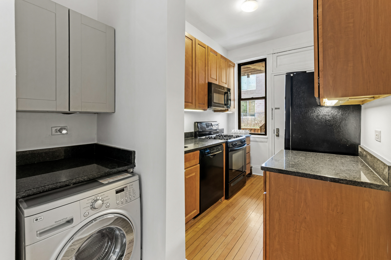 728 West Sheridan Road, Unit 2N Chicago, IL 60613 - Photo 9 of 18 a kitchen with stainless steel appliances granite countertop a stove a sink and a refrigerator