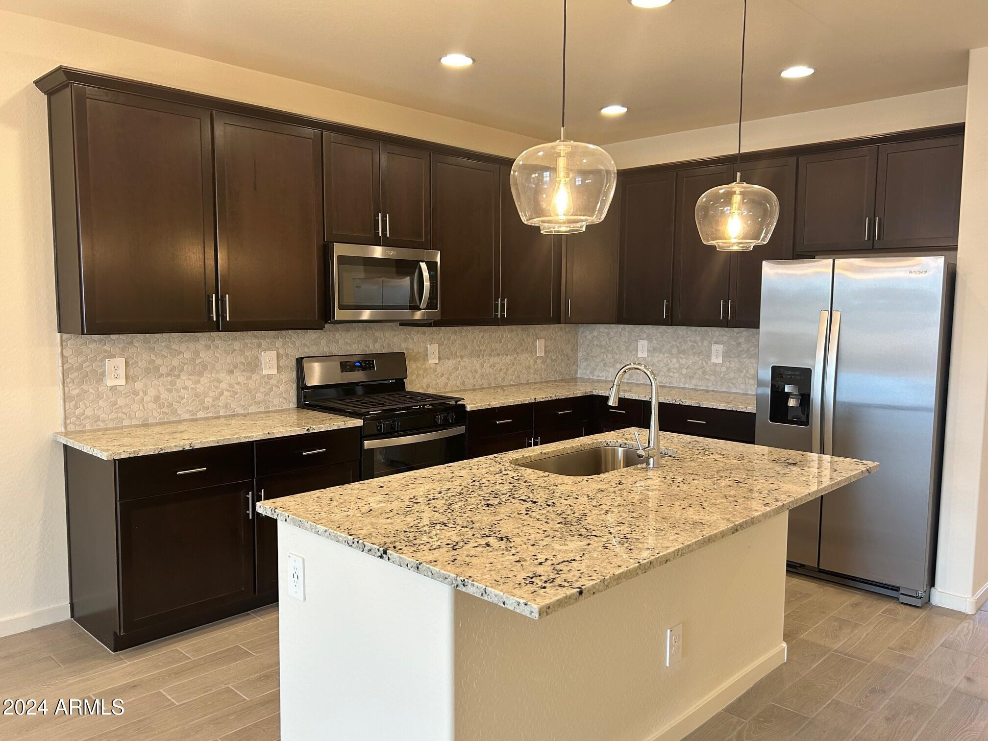 20520 North Candlelight Road Maricopa, AZ 85138 - Photo 3 of 18 a kitchen with stainless steel appliances granite countertop granite counter tops and a refrigerator