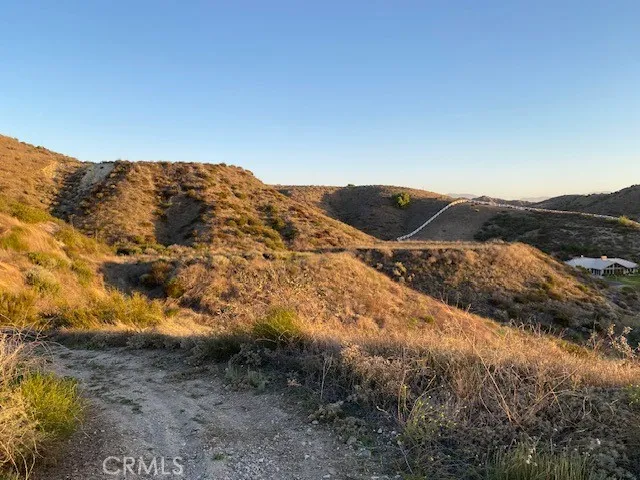 a view of a mountain in the distance in a field