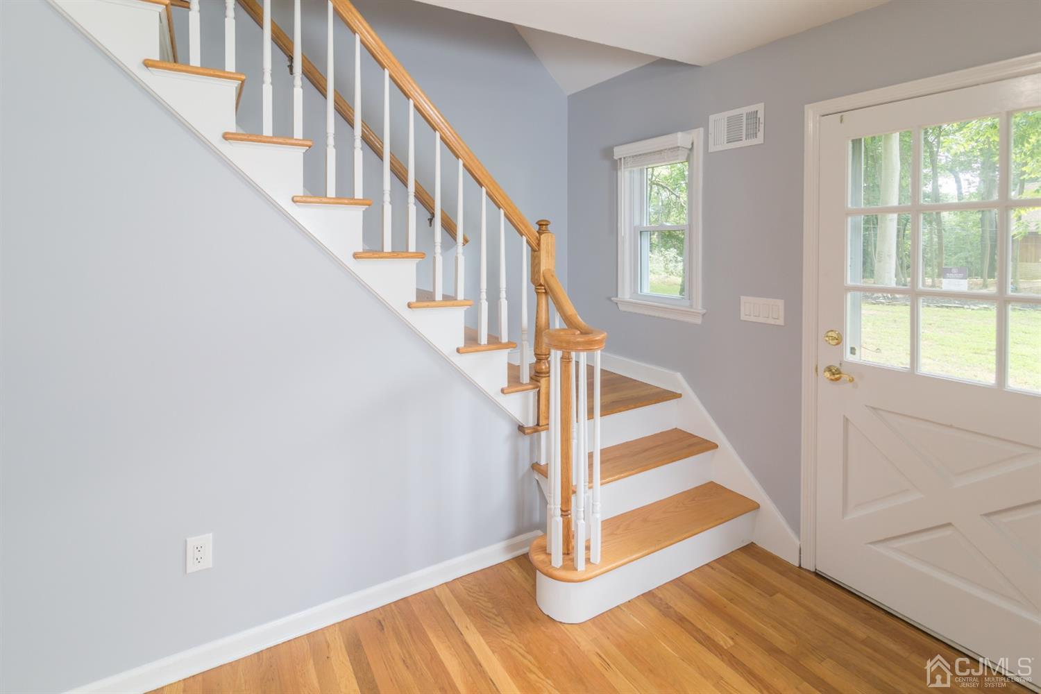 6 Coventry Square Holmdel, NJ 07733 - Photo 12 of 36 a view of entryway with wooden floor and stairs