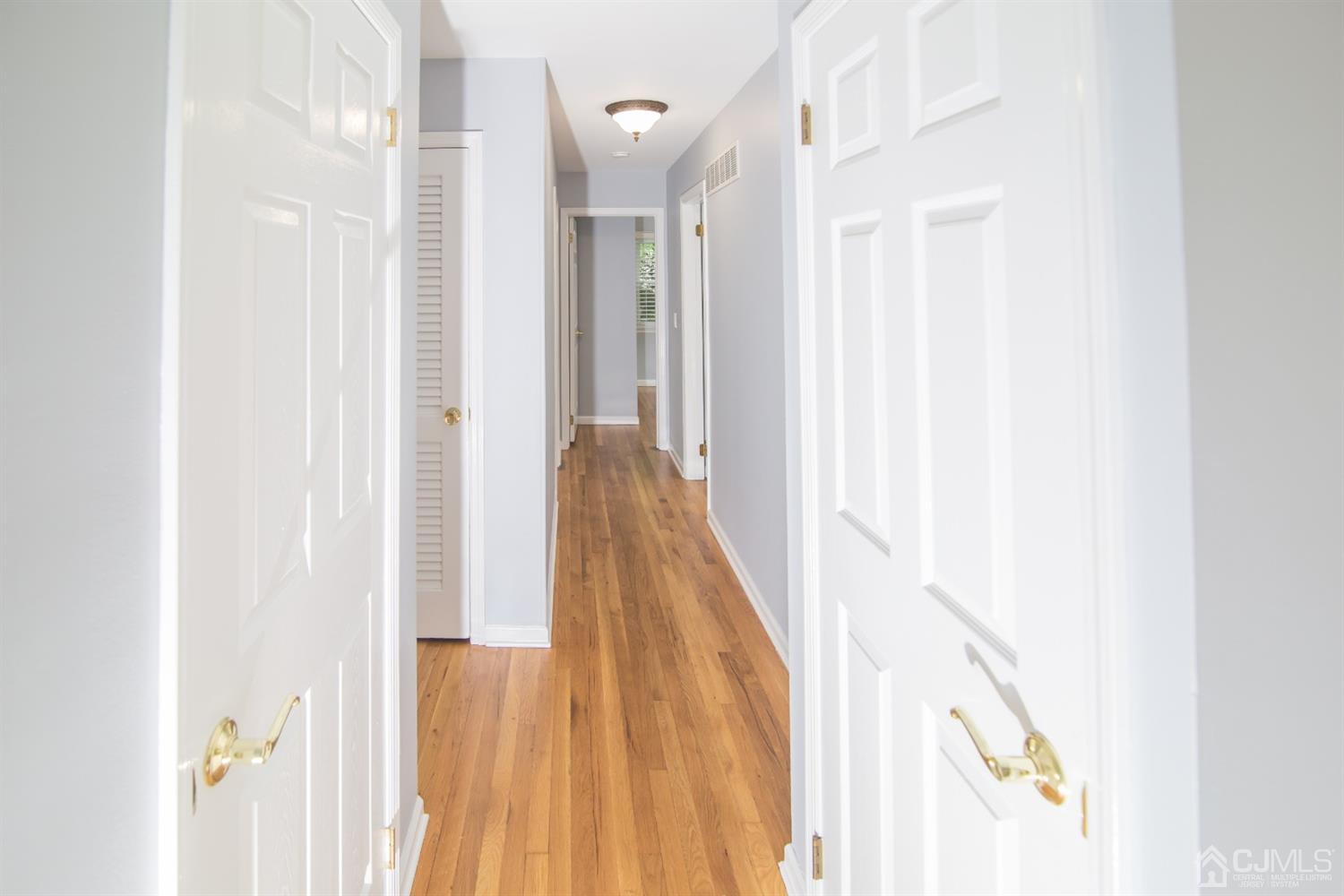 6 Coventry Square Holmdel, NJ 07733 - Photo 13 of 36 a view of a hallway with wooden floor and staircase