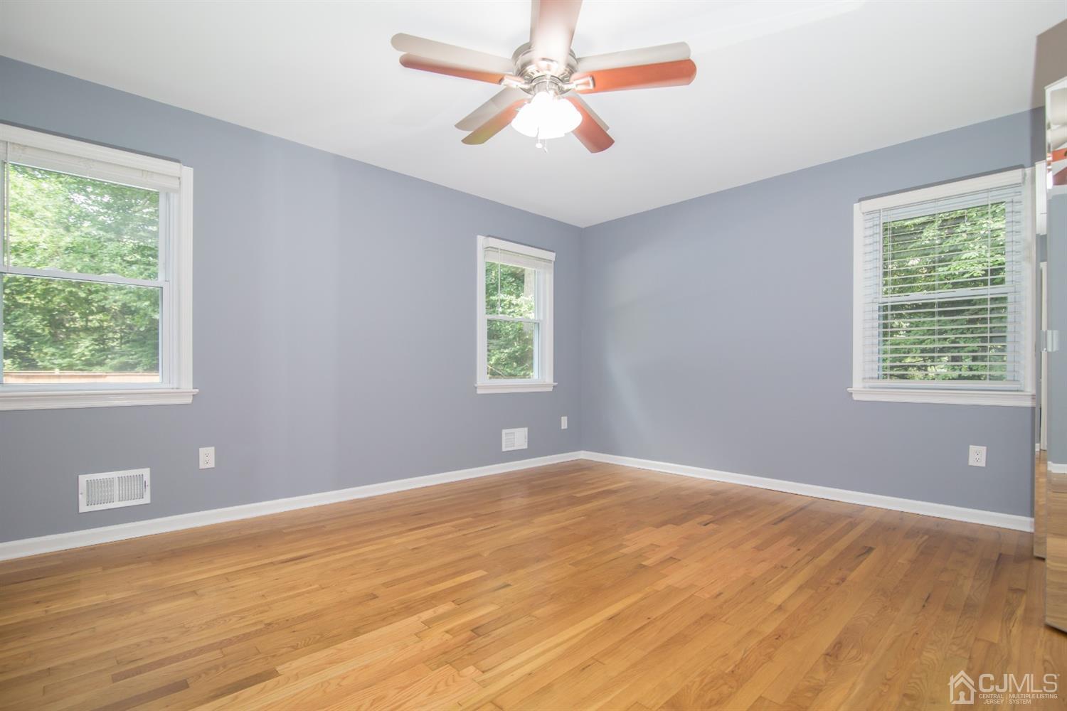 6 Coventry Square Holmdel, NJ 07733 - Photo 14 of 36 a view of an empty room with window and chandelier fan