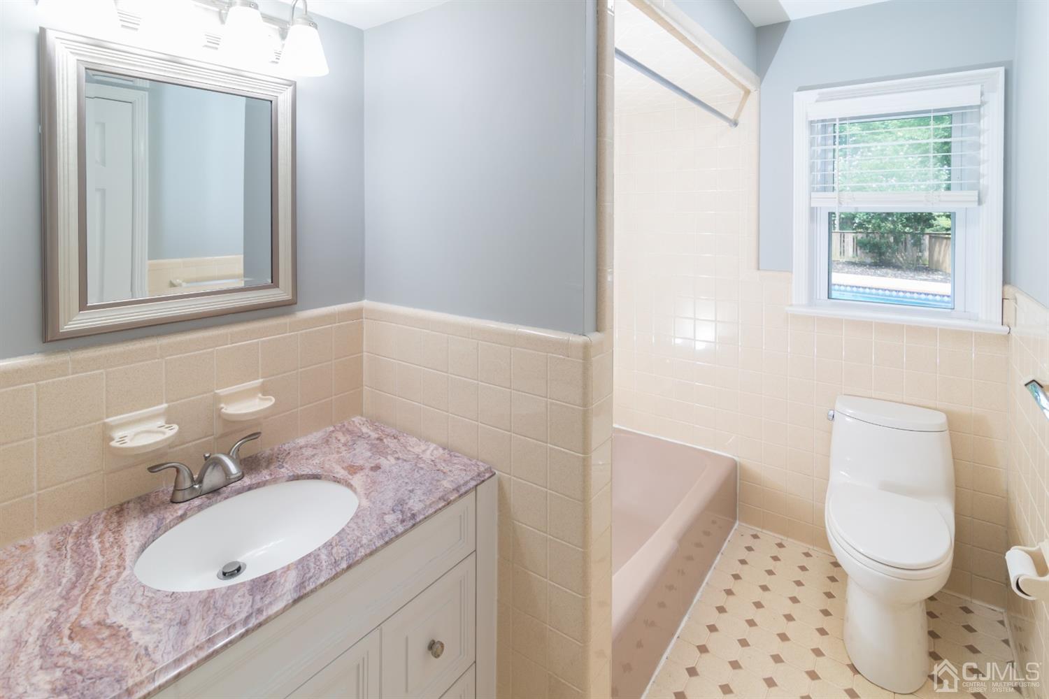 6 Coventry Square Holmdel, NJ 07733 - Photo 15 of 36 a bathroom with a granite countertop sink toilet and mirror