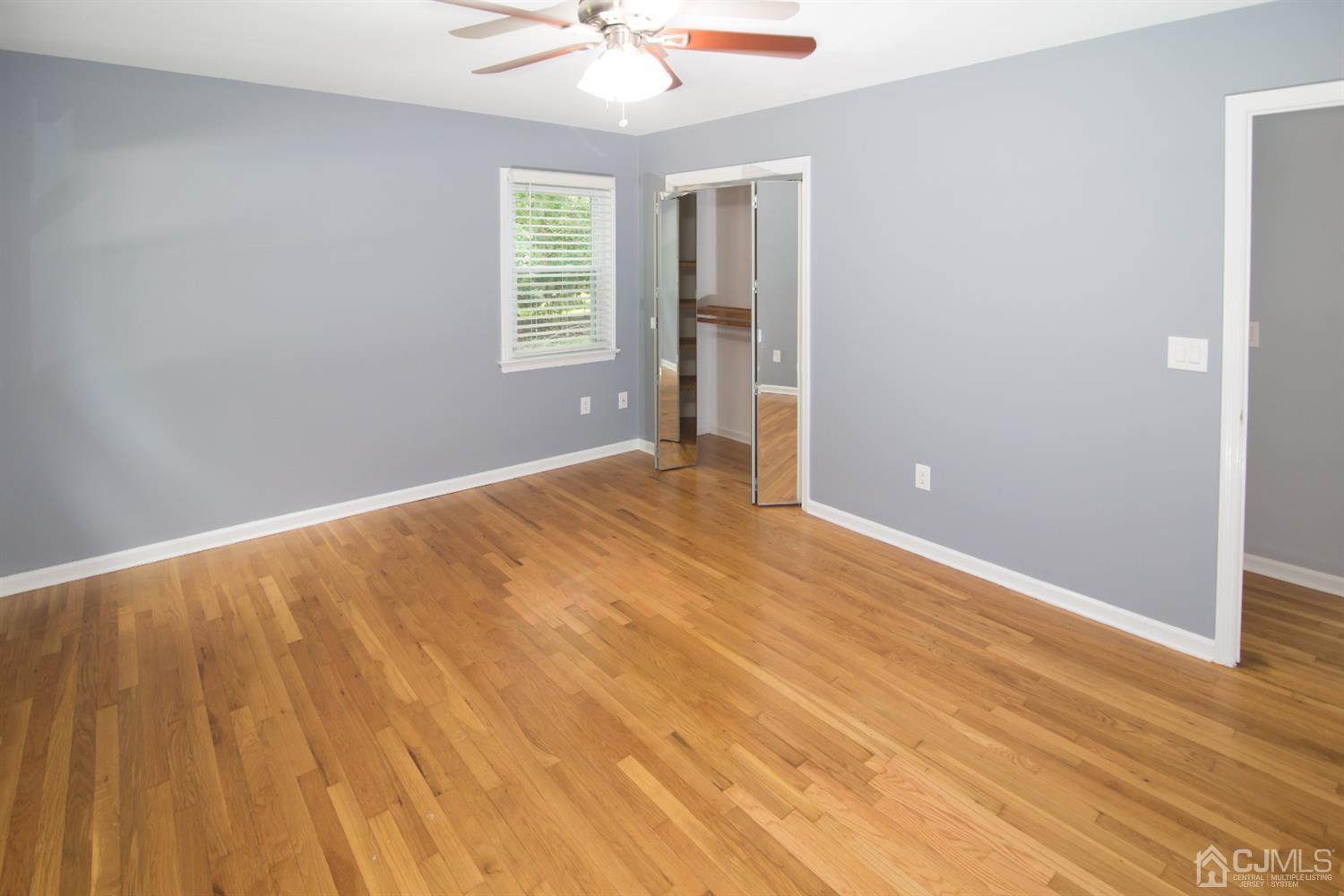 6 Coventry Square Holmdel, NJ 07733 - Photo 16 of 36 an empty room with wooden floor and windows