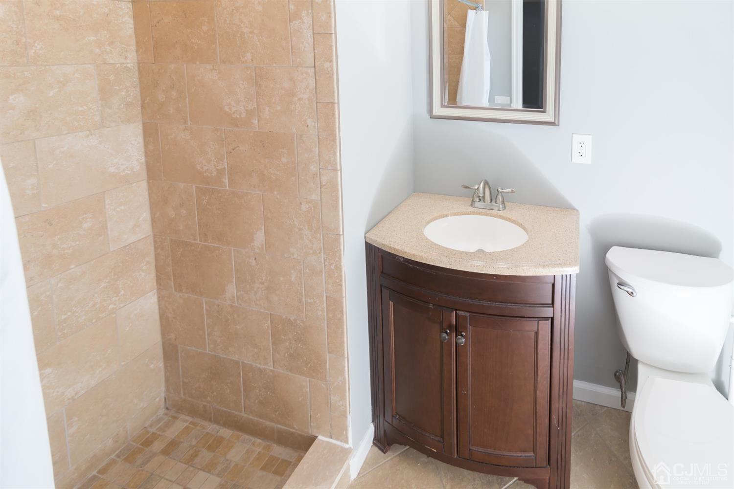 6 Coventry Square Holmdel, NJ 07733 - Photo 17 of 36 a bathroom with a sink toilet and shower